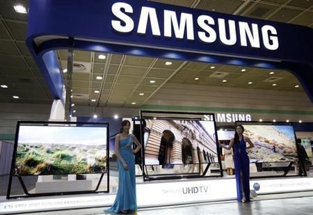 Models pose with Samsung Electronics' Ultra HD LCD televisions during World IT show 2013 at the Coex convention centre in Seoul